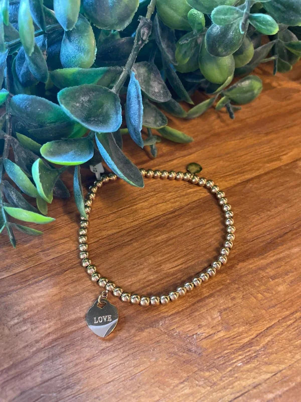 Elastieken kralenarmband goud met bedels